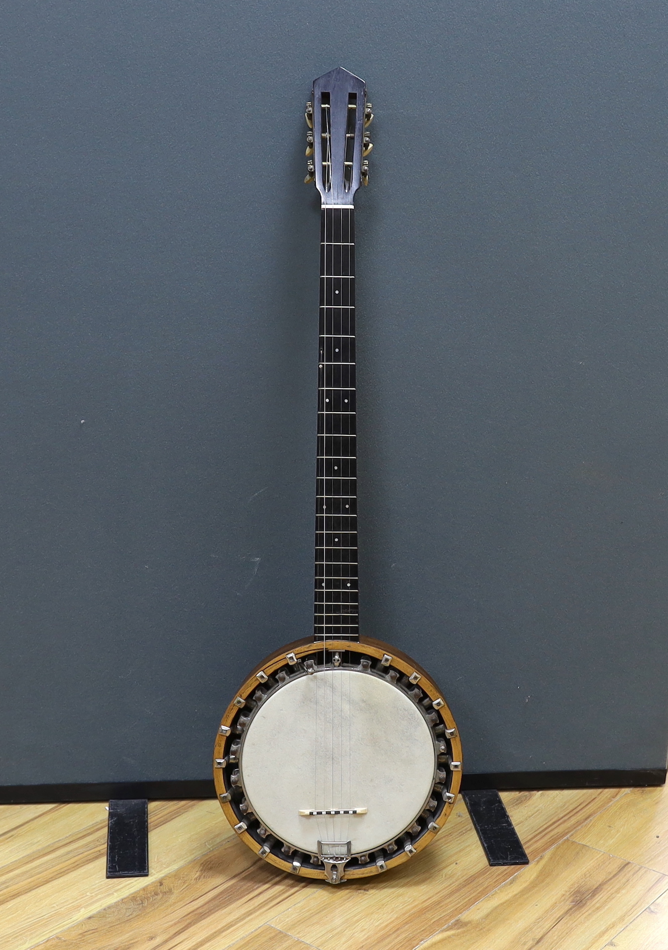 A six string banjo, unmarked, in a hard case by Ashbury